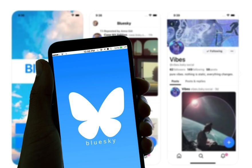 A photo of a phone with the Bluesky logo on screen