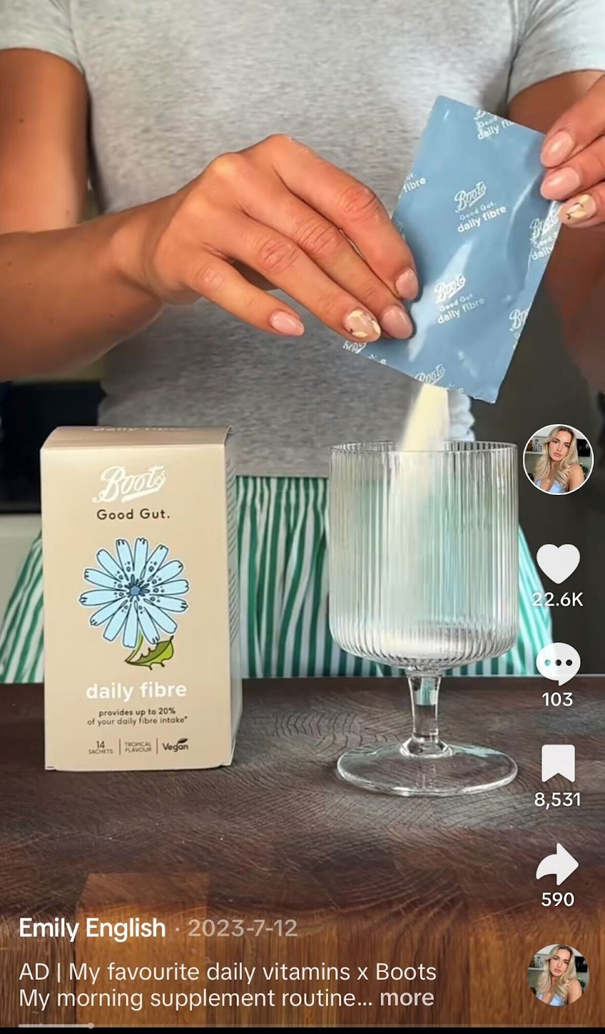 woman pouring sachet of daily fiber into a glass of water