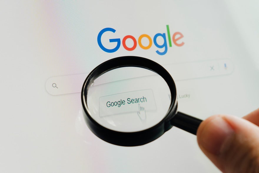 Magnifying glass hovering over the Google homepage search bar
