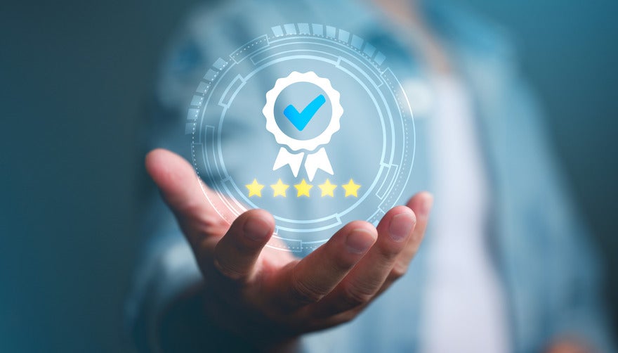 Palm facing up with a icon of a badge and five stars floating in the hand