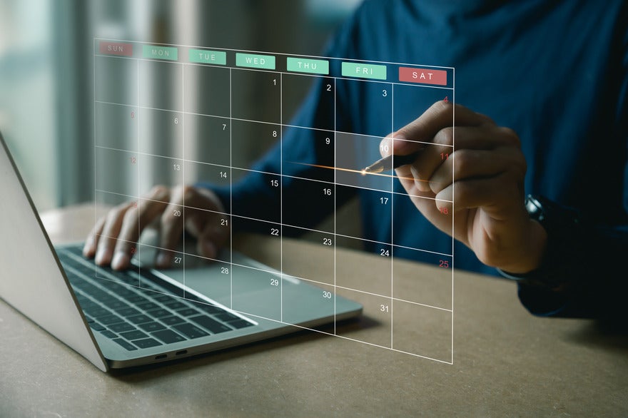 See through calendar visual floating above a laptop with a person pointing to a date
