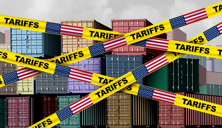 Cargo containers with yellow tape across the image showing the word "Tariffs" and the US flag