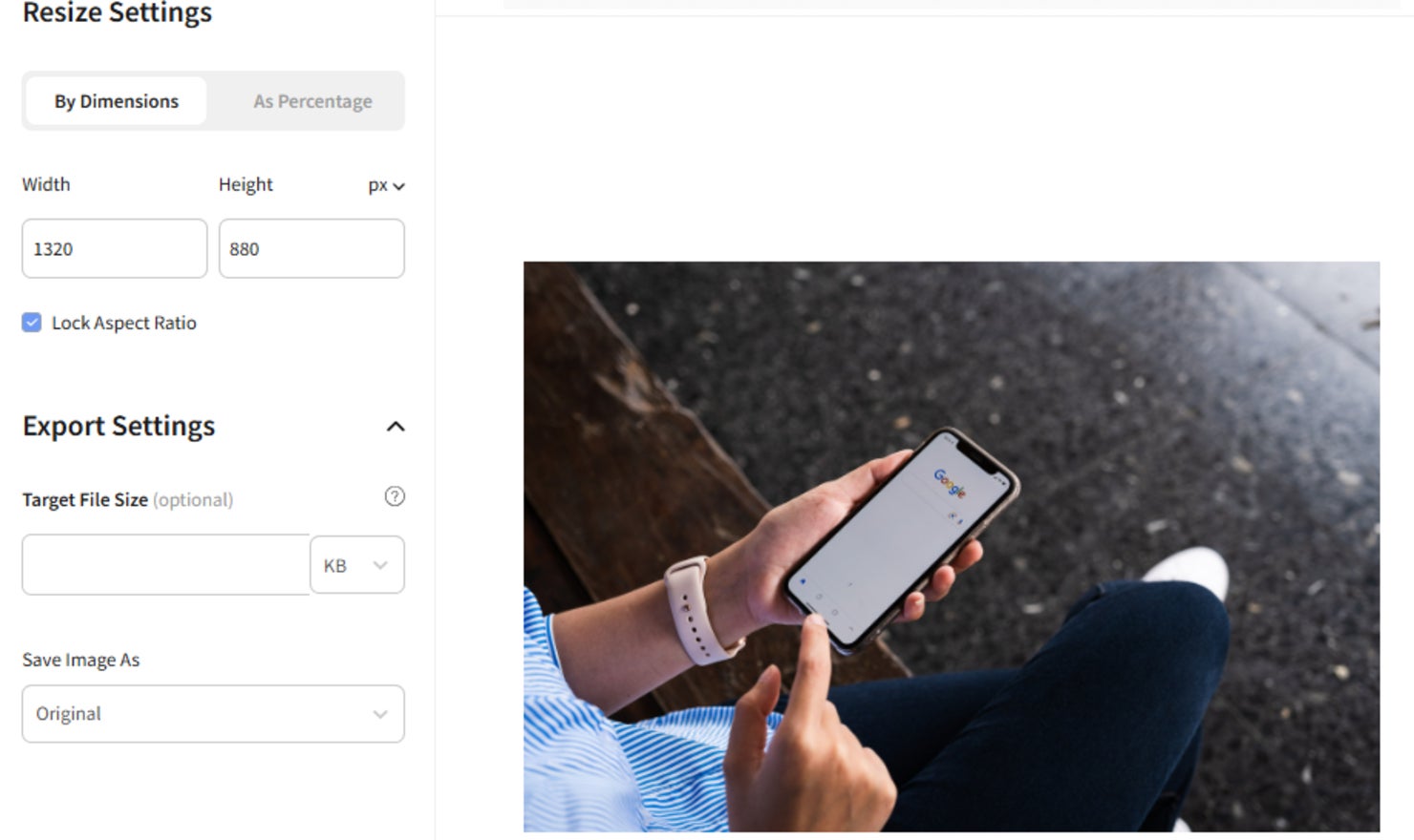 image of a person looking at their phone being resized with the image resizer tool