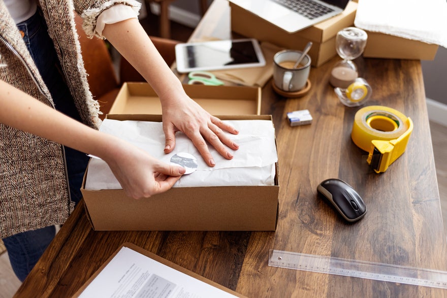 Person packaging a product on a table