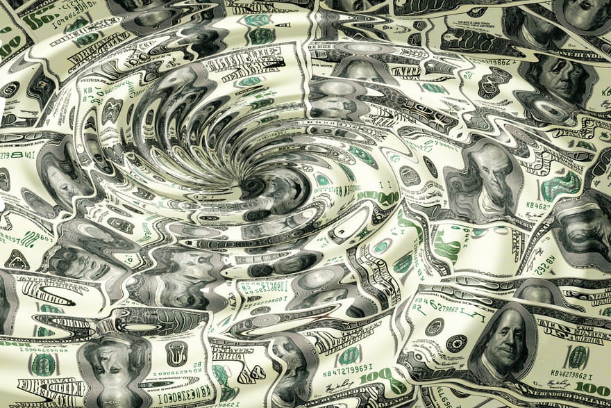 US dollars distorted by a water whirlpool