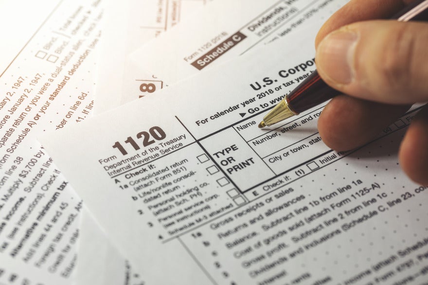Person filling out a US tax form