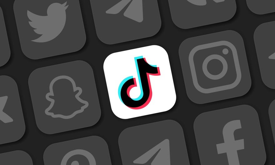 Different social media logos in black and white with the TikTok logo in colour at the centre
