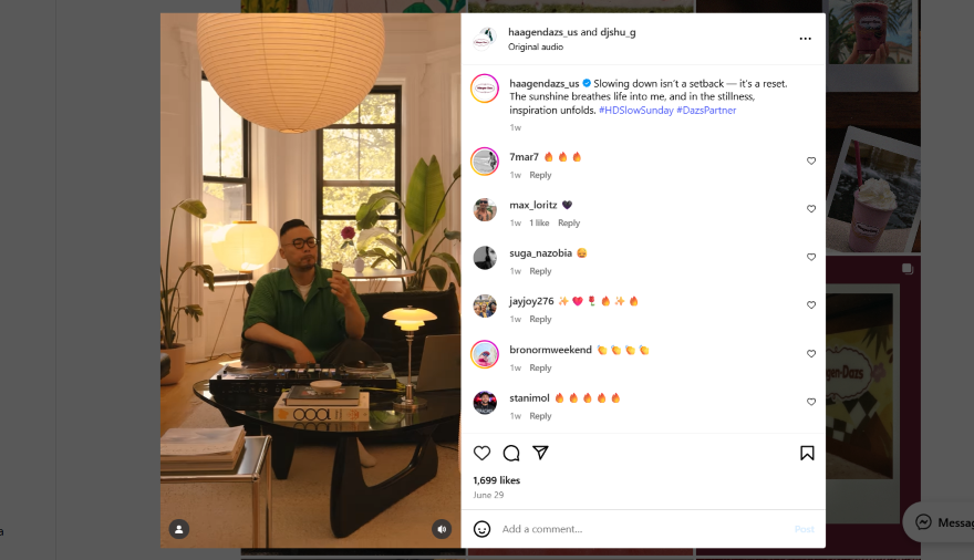 Instagram reel screenshot of a man in a green shirt sitting at a table with a record player, surrounded by plants and large windows.