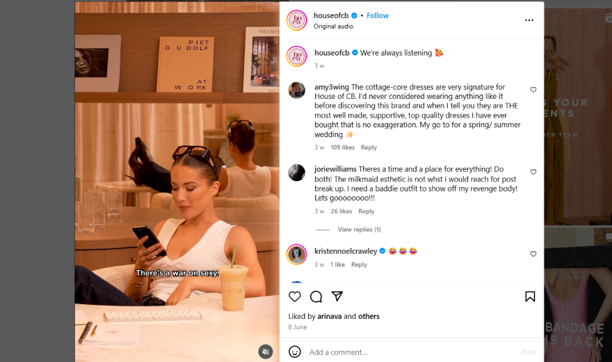 Instagram video of a woman in a white tank top sitting at her desk looking at her phone.